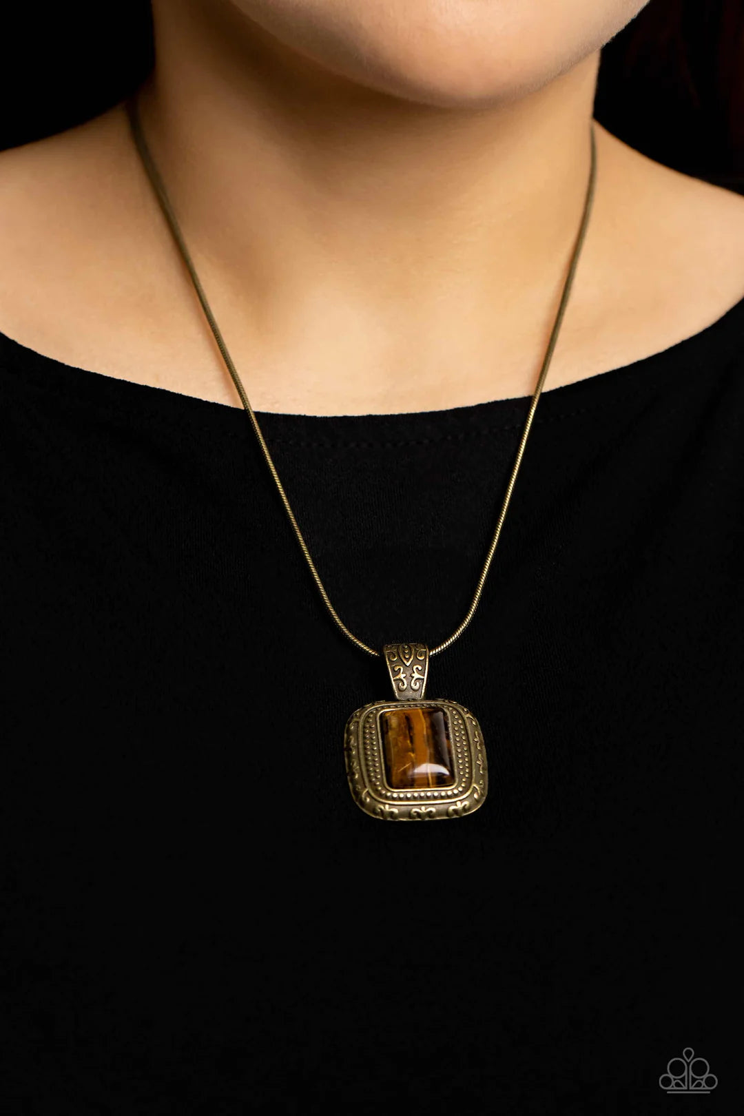 Paparazzi Accessories Right Hand TALISMAN - Brass A rectangular tiger's eye stone is pressed into the center of a studded brass frame bordered in decorative filigree at the bottom of a rounded brass snake chain, creating a mystical talisman below the coll