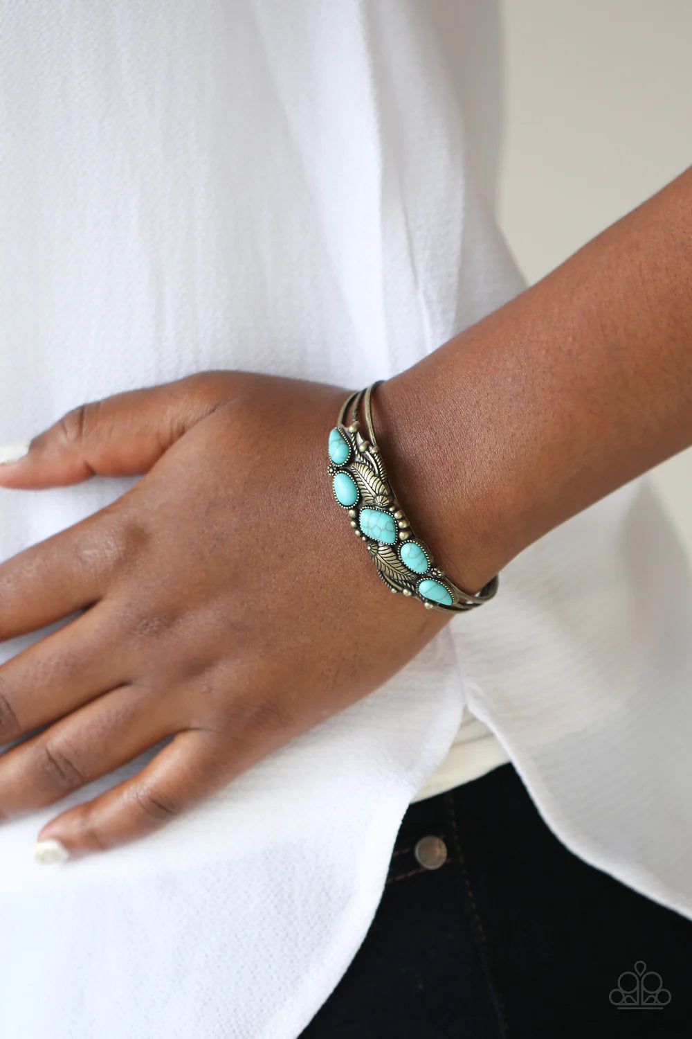 Paparazzi Accessories Cottage Living - Brass A collection of asymmetrical turquoise stones adorns the front of a studded brass frame embossed in floral and feathery accents atop a layered brass cuff. Sold as one individual bracelet. Jewelry
