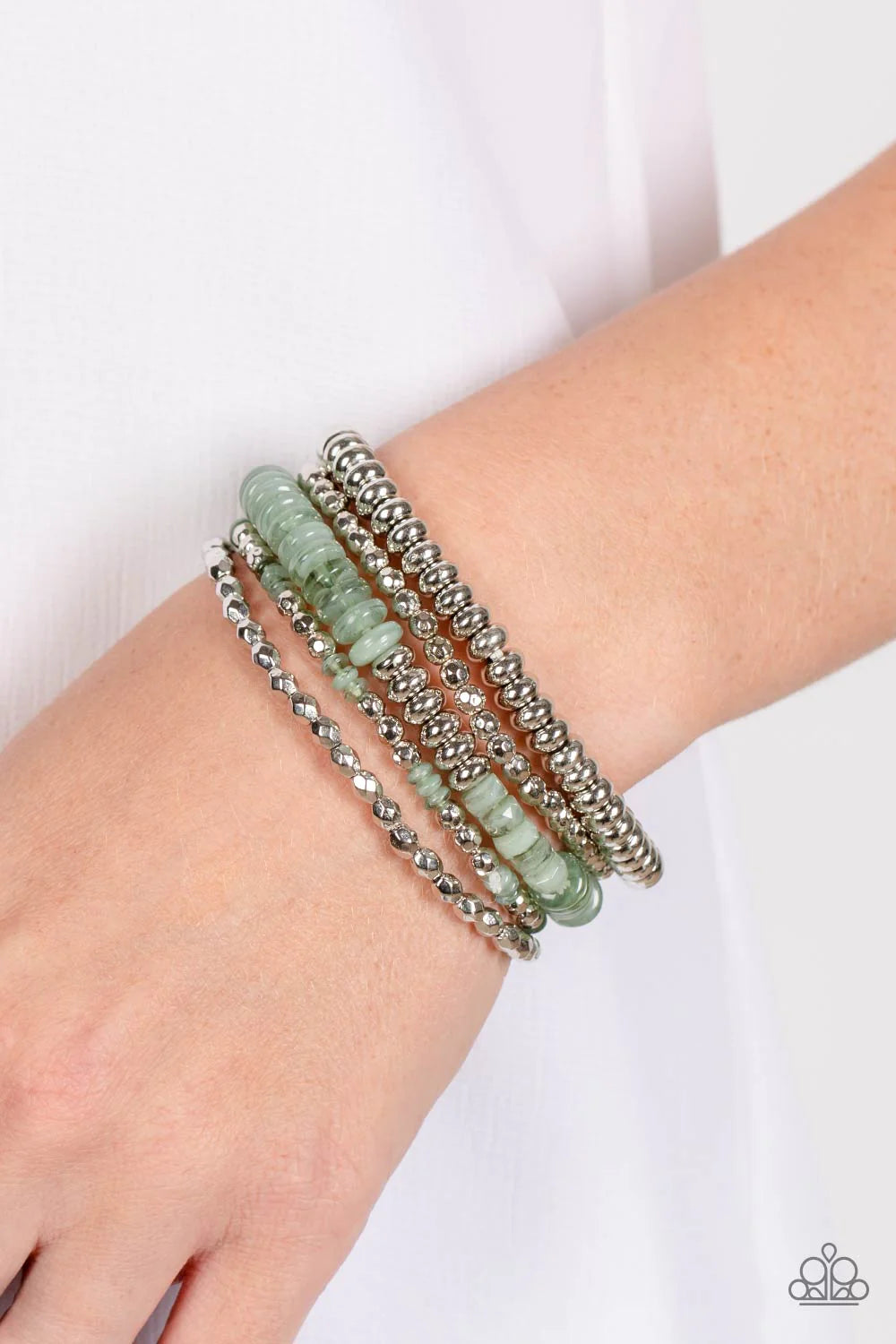 Paparazzi Accessories Pristine Pixie Dust - Green Varying sizes and textures of silver beads combine with a collection of solid, milky, and cloudy beads in varying sizes, to create a playful stack of bracelets that layer across elastic stretchy bands. Fea