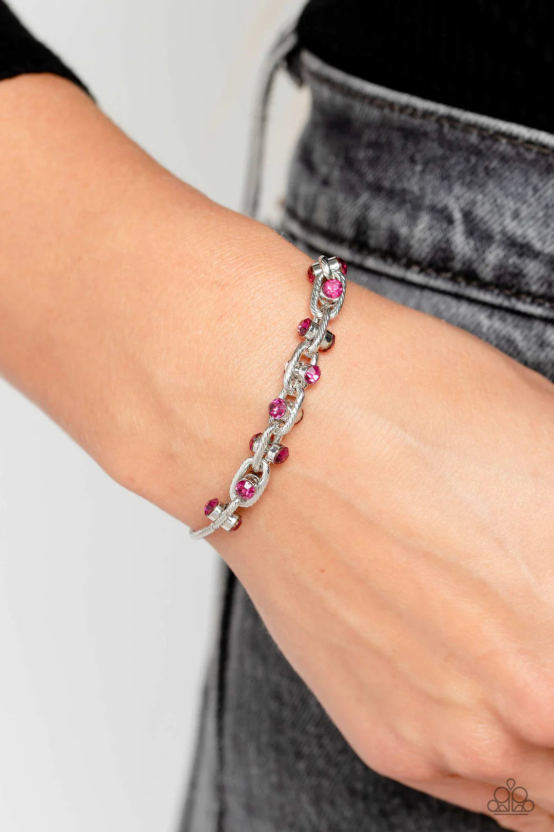 Paparazzi Accessories Intertwined Illusion - Pink Silver oval links lined with texture interlock around one another at the end of a silver snake chain. Featured in the center of each link, a double-sided pendant with dainty fuchsia rhinestones glimmers fo