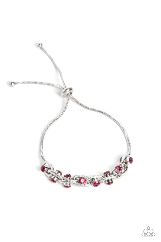 Paparazzi Accessories Intertwined Illusion - Pink Silver oval links lined with texture interlock around one another at the end of a silver snake chain. Featured in the center of each link, a double-sided pendant with dainty fuchsia rhinestones glimmers fo
