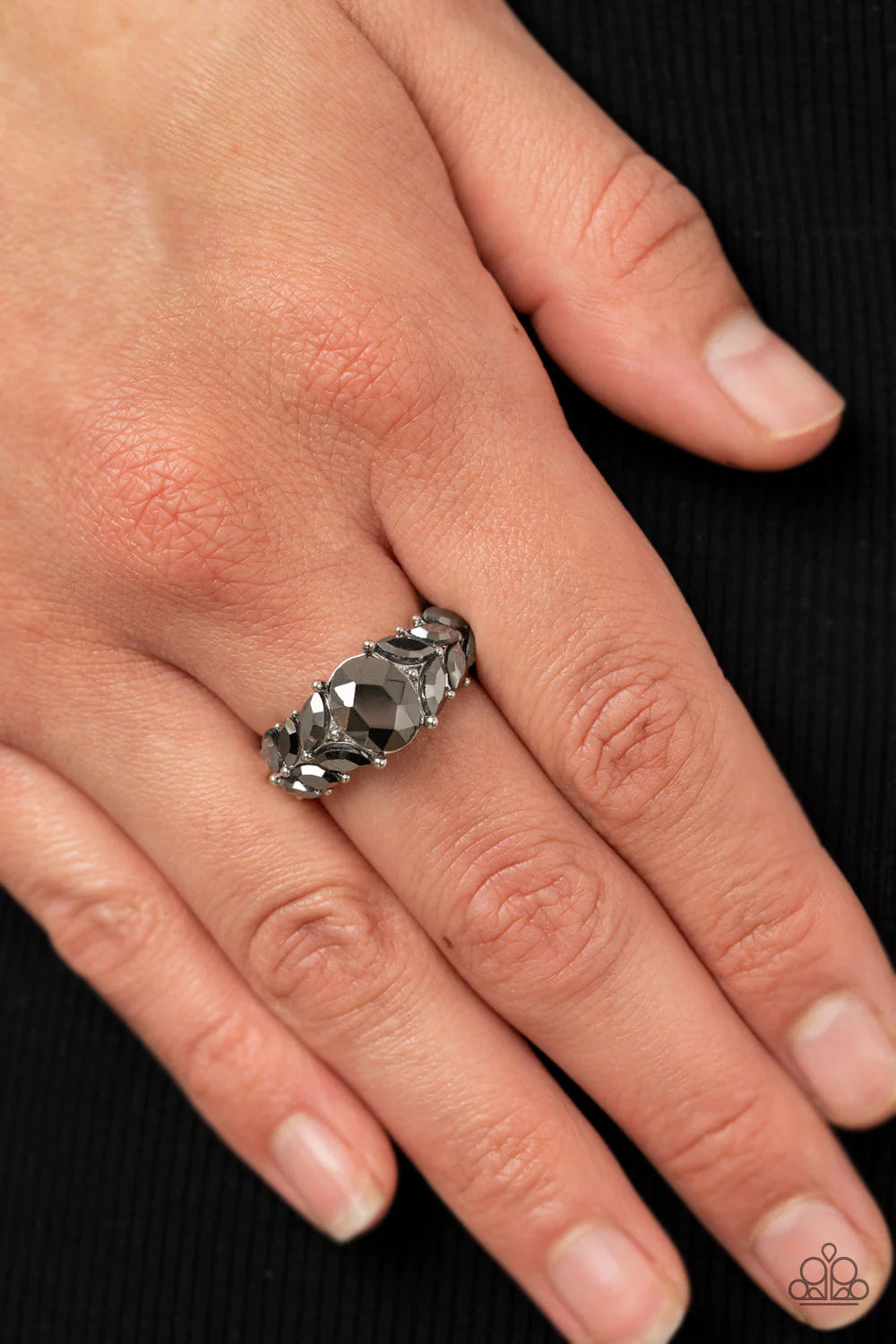 Paparazzi Accessories Smooth Smolder - Silver Pairs of marquise cut hematite rhinestones fan out from an oversized hematite rhinestone, creating glitzy leafy accents across the front of a dainty and studded silver band. Features a dainty stretchy band for