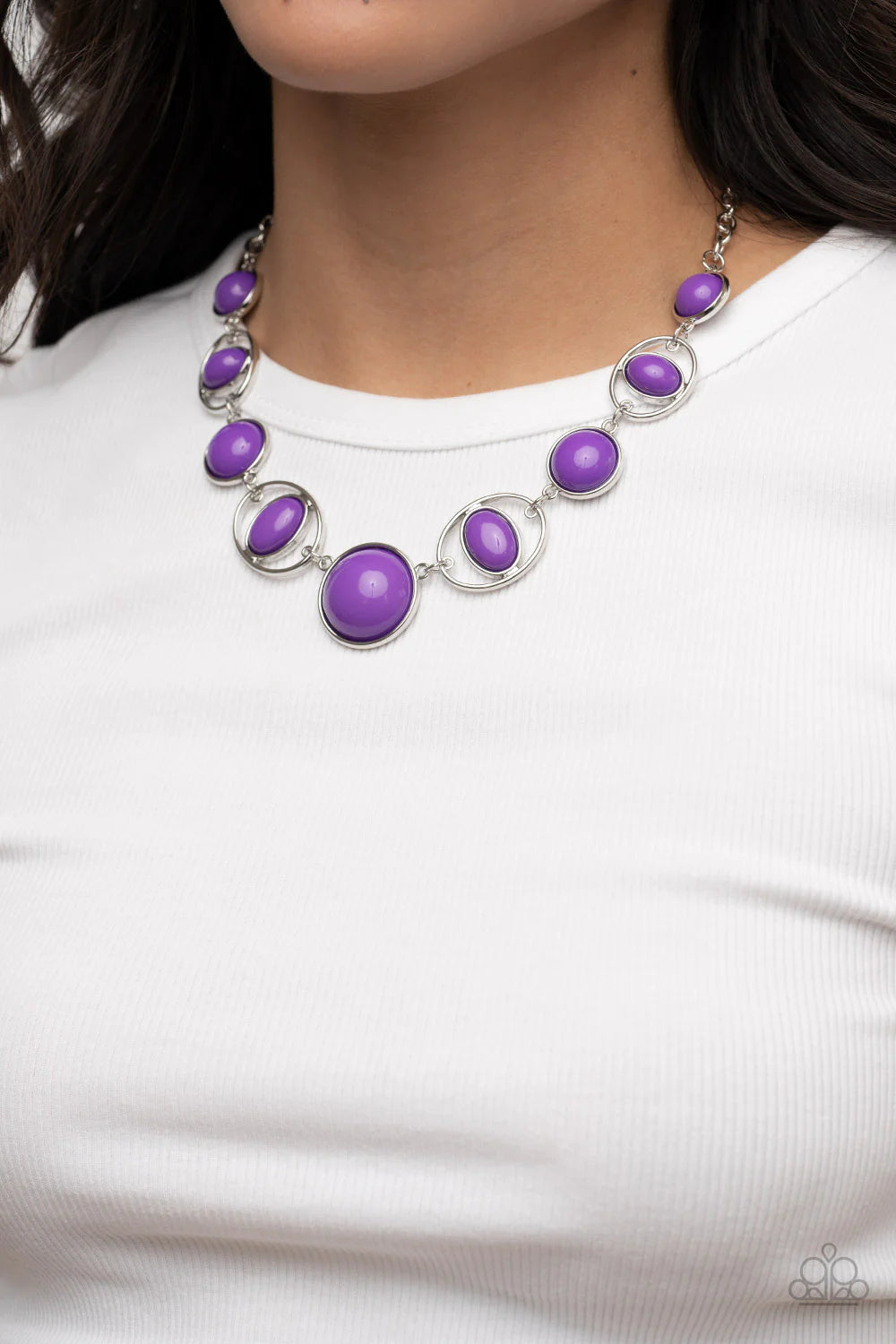 Paparazzi Accessories Eye of the BEAD-holder - Purple Encased in sleek silver frames, a bubbly collection of oversized purple beads alternate with oval purple beaded hoops below the collar for a bodacious pop of color. Features an adjustable clasp closure