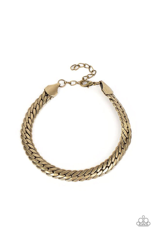 Paparazzi Accessories Cargo Couture - Brass Brushed in a high-sheen finish, a thick, brass chain wraps around the wrist for an industrial look. Featured within the design, the chain seems to tightly stack on top of itself, emitting light from every angled