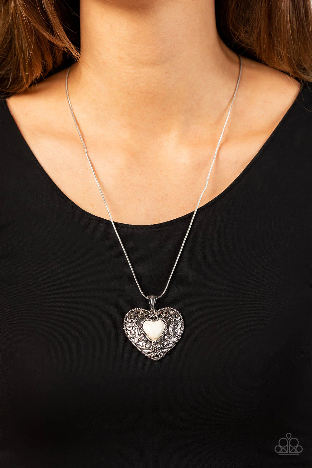 Paparazzi Accessories Wholeheartedly Whimsical - White Embossed in whimsical flowers and vines, a rustic silver heart frame is adorned with a white stone heart center for an adoring artisan finish as it glides along a rounded silver snake chain across the