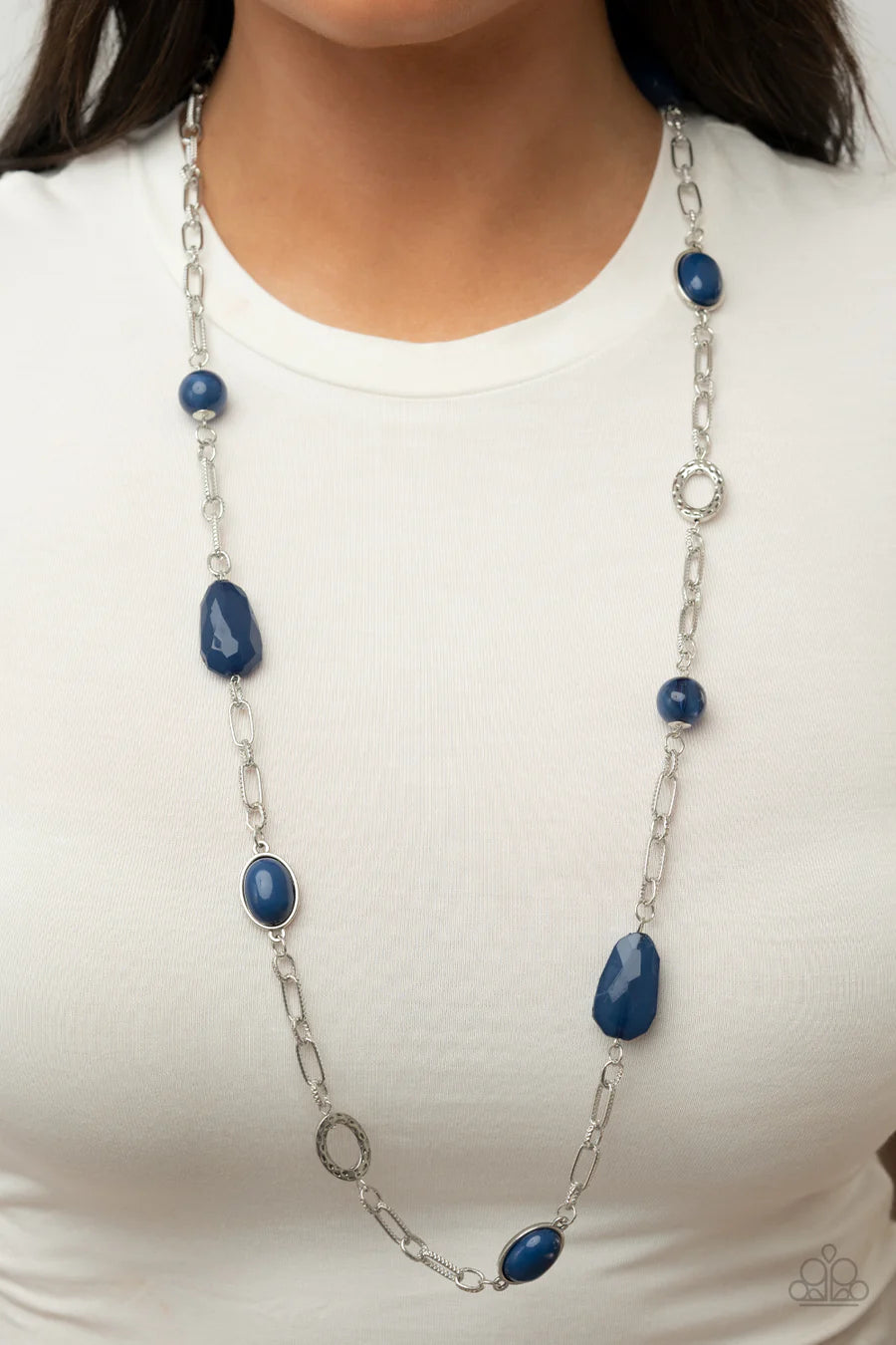 Paparazzi Accessories Barcelona Bash - Blue A mismatched assortment of blue beaded frames, hammered silver rings, and glassy and faceted blue acrylic accents adorns textured sections of shimmery silver chain across the chest, resulting in a refreshing pop