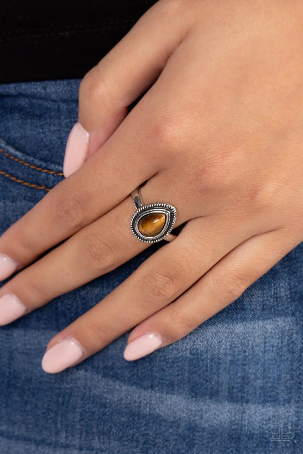 Paparazzi Accessories Eco Elements - Brown A tiger's eye teardrop stone is pressed into the center of a textured silver frame atop a dainty silver band, creating an earthy statement piece. Features a dainty stretchy band for a flexible fit. As the stone e