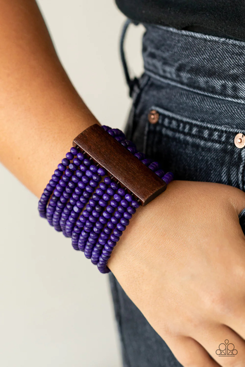 Paparazzi Accessories Waikiki Wonderland - Purple Held together with brown wooden rectangular frames, rows of vivacious purple wood beads are threaded along stretchy bands around the wrist for a whimsically layered look. Sold as one individual bracelet. J