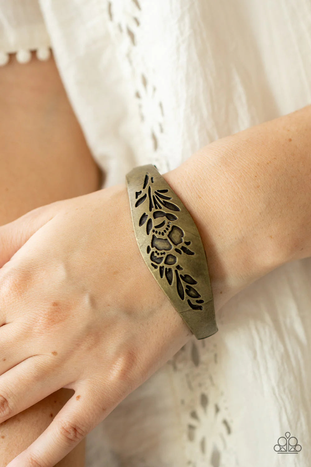 Paparazzi Accessories Fond of Florals - Brass The front of a thick antiqued brass bangle-like bracelet is stamped in a leafy floral pattern, creating a whimsy centerpiece around the wrist. Features a hinged closure. Sold as one individual bracelet. Jewelr