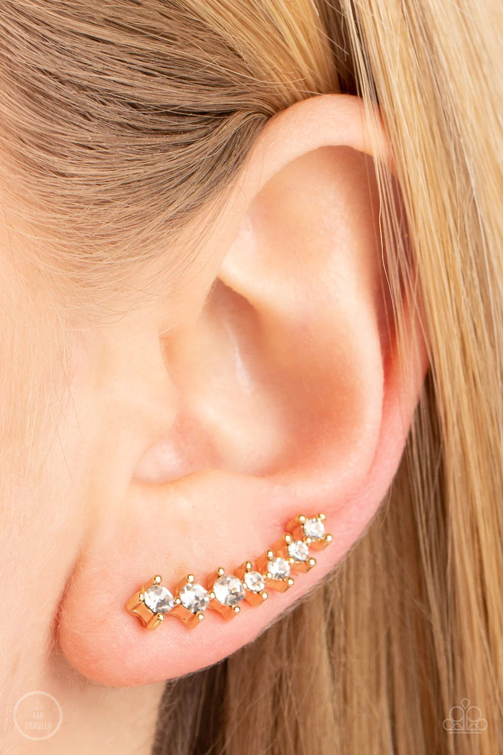 Paparazzi Accessories PRISMATIC and Proper - Gold Featuring pronged gold fittings, glassy white rhinestones gradually increase in size as they climb the ear for a trendy twinkle. Features a dainty cuff attached to the top for a secure fit. Sold as one pai