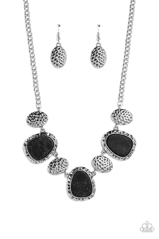 Paparazzi Accessories Badlands Border - Black Hammered in a blinding finish, rippling silver oval discs combine with abstract hammered frames. Set inside the rippling silver frames, abstract black oval stones create a startling pop of color against the ch