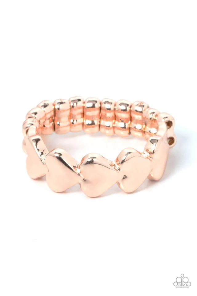 Paparazzi Accessories Rhythm of Love - Rose Gold Brushed in a high sheen shimmer, a dainty row of rose gold heart frames repeats across the finger for a romantic flair. Features a dainty stretchy band for a flexible fit. Jewelry