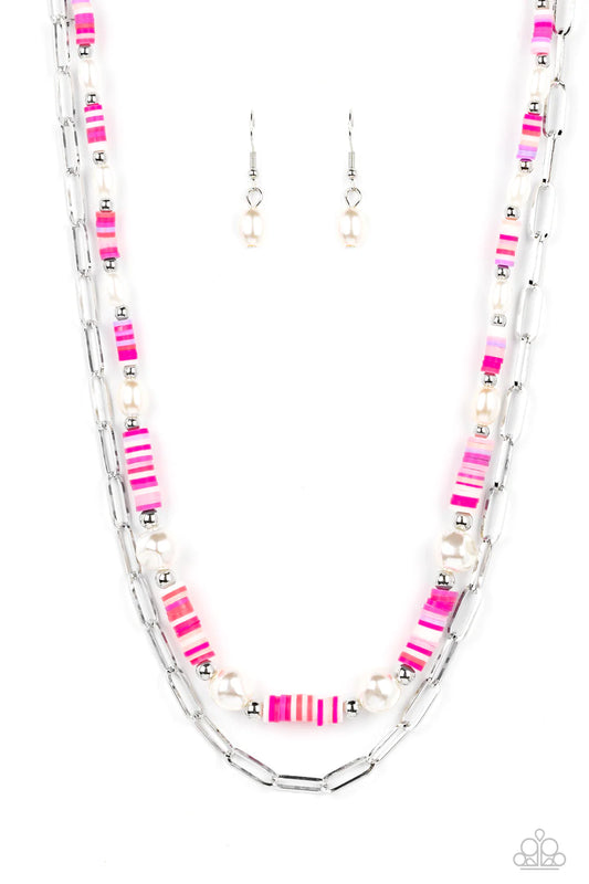Paparazzi Accessories Tidal Trendsetter - Pink Sections of colorful rubber discs in shades of pink, purple, and white are separated by tiny silver beads and a variety of white baroque pearls to create an unexpected mashup of texture along the collar. A st