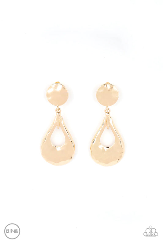 Paparazzi Accessories Metallic Magic - Gold A hammered gold teardrop swings from the bottom of a hammered gold disc, resulting in monochromatic magic. Earring attaches to a standard clip-on fitting. Sold as one pair of clip-on earrings.