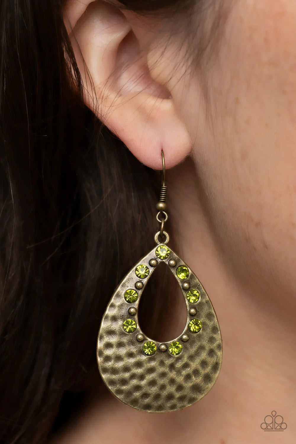 Paparazzi Accessories Terraform Twinkle - Green Glittery green rhinestones and dainty brass studs adorn the inner, airy teardrop cutout inside of a hammered brass teardrop, resulting in a rustically refined lure. Earring attaches to a standard fishhook fi