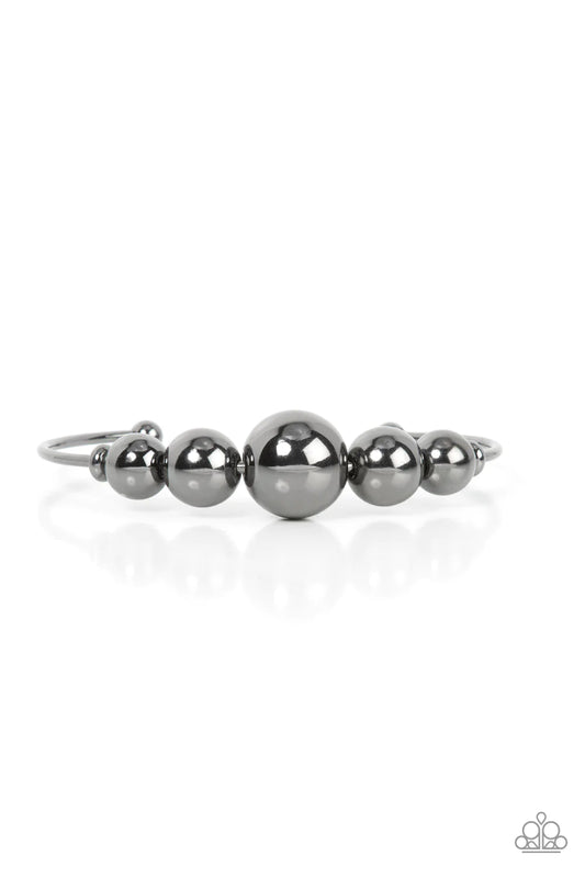 Paparazzi Accessories Bead Creed - Black Gradually increasing in size, an oversized collection of gunmetal beads are threaded along a dainty gunmetal cuff for a dramatic industrial display. Sold as one individual bracelet. Jewelry