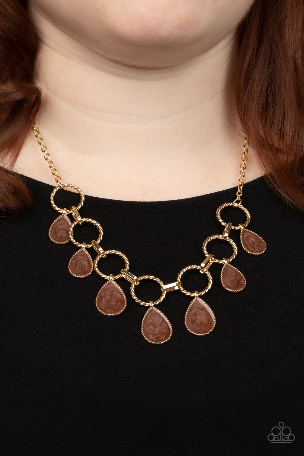Paparazzi Accessories Golden Glimmer - Brown Swirling with brown glazed finishes, textured gold teardrops swing from the bottoms of spun gold hoops that link with pinched gold fittings below the collar, resulting in a refined fringe below the collar. Feat