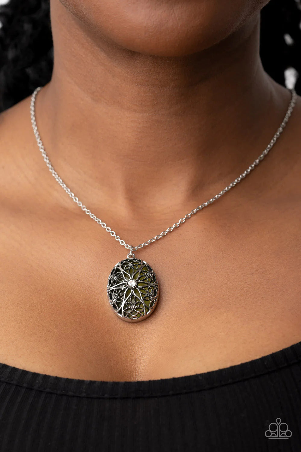 Paparazzi Accessories Venice Vacation - Green Dotted with a glitzy white rhinestone center, studded and smooth floral filigree detail blooms across the front of an oversized and Olive Branch cat's eye stone, resulting in a whimsical pendant at the bottom
