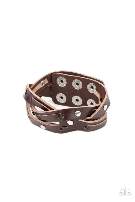 Paparazzi Accessories Rugged Roundup - Brown Featuring sections of silver studs and leather laces, brown leather bands weave into a rugged braid around the wrist. Features an adjustable snap closure. Jewelry