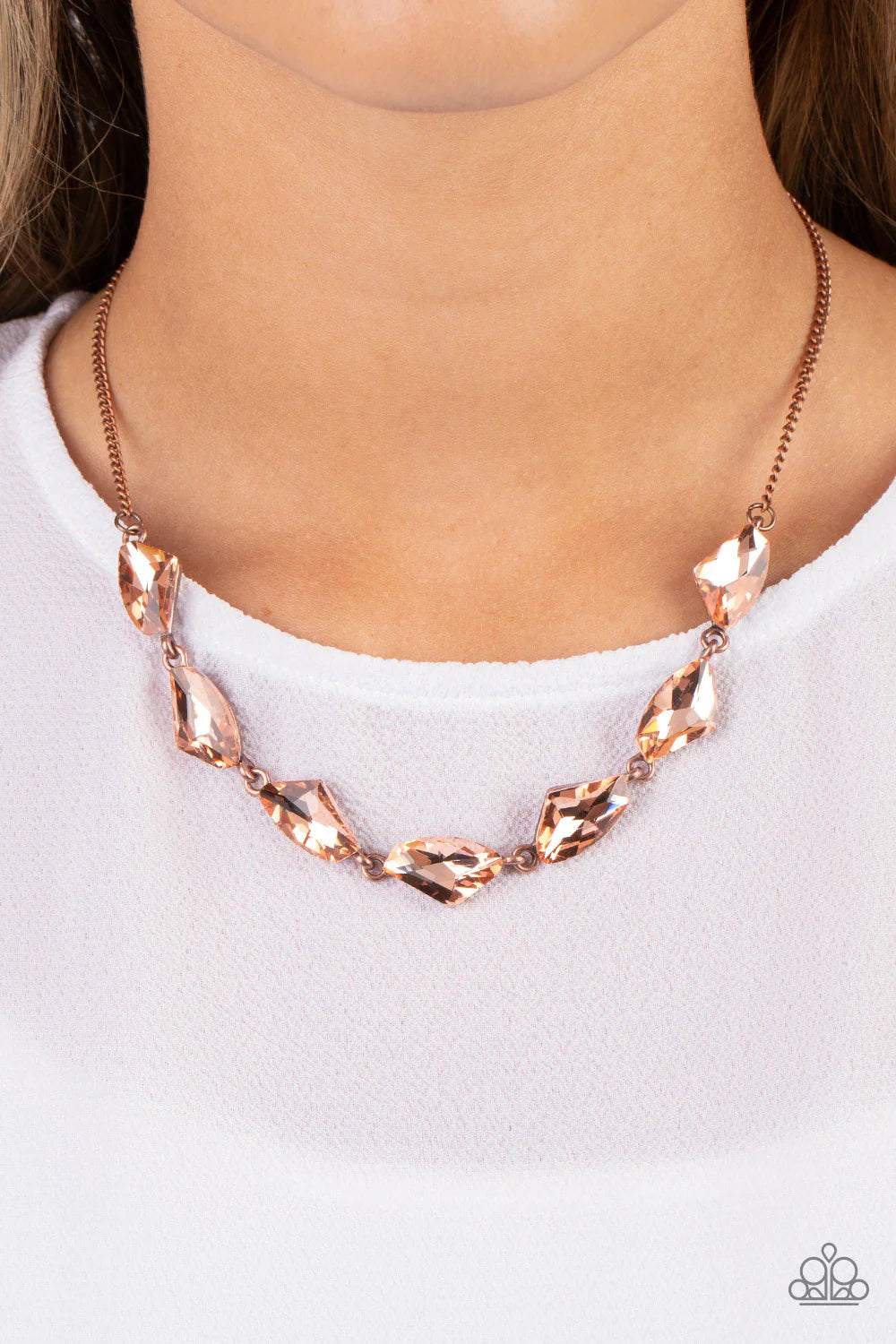 Paparazzi Accessories Raw Rapture - Copper A jagged collection of coppery rhinestones falls along the neckline in a fierce display. The asymmetrical cuts of each rhinestone are emphasized by their dramatic faceted surfaces, bouncing light in every directi