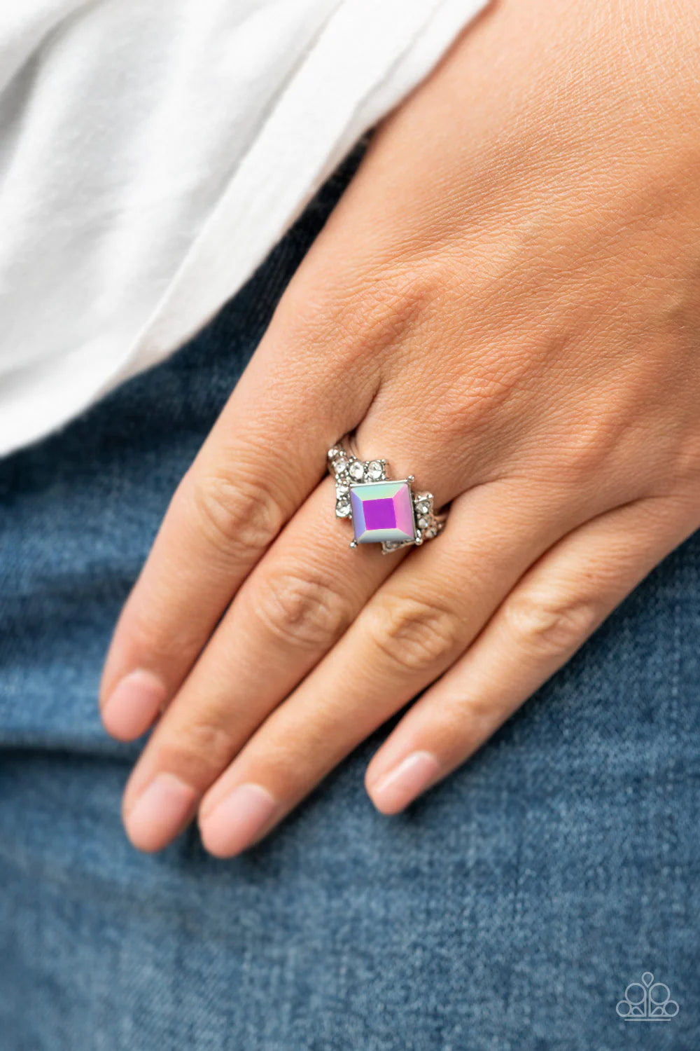 Paparazzi Accessories Mind-Blowing Brilliance - Purple Featuring a stellar iridescence, a tilted purple gem adorns the center of a white rhinestone dotted silver band featuring stacked and studded detail. Features a dainty stretchy band for a flexible fit