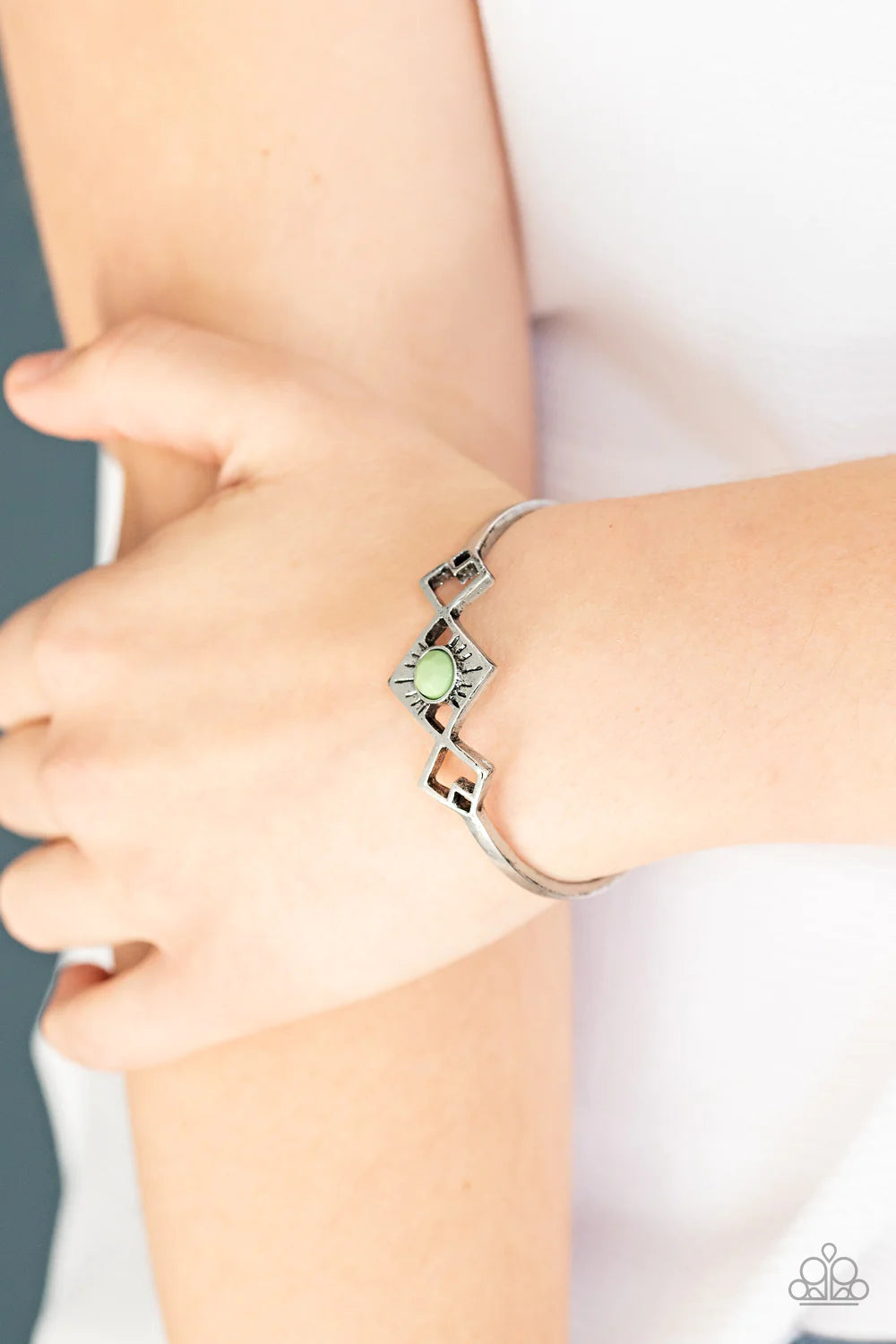 Paparazzi Accessories Dainty Deco - Green Featuring a green beaded center, tilted square frames attach to a dainty silver cuff, creating an abstract centerpiece.Sold as one individual bracelet.