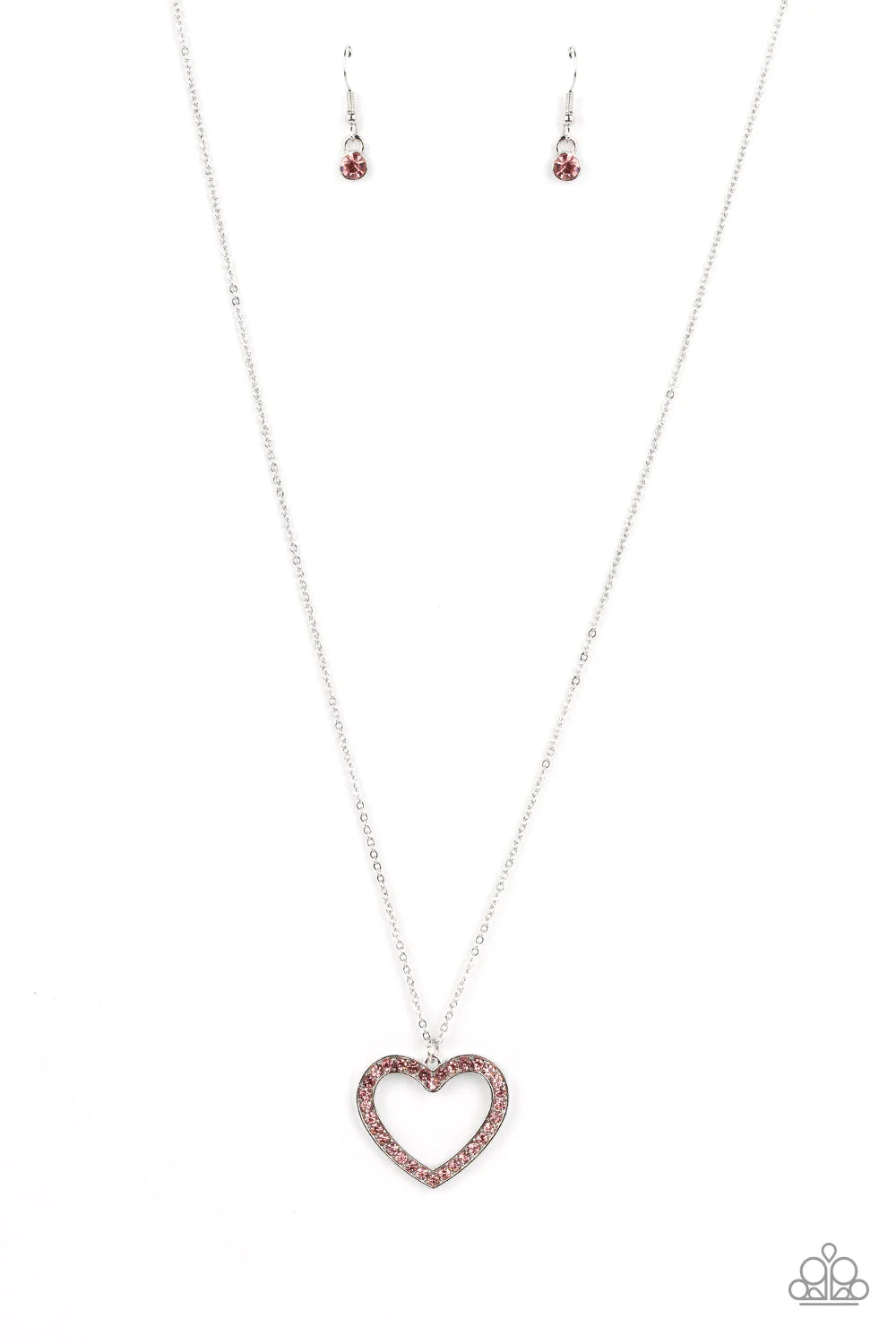 Paparazzi Accessories Dainty Darling - Pink A silver heart-shaped silhouette is outlined with a border of light rose rhinestones and suspended from the bottom of a long silver chain. The colorful rhinestones infuse the simple concept with irresistible spa