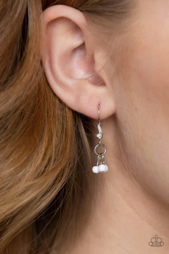 Paparazzi Accessories Boho Baby - White Embossed in tribal inspired patterns, silver half-moon frames link below the collar. Dainty white beads swing from the bottoms of the ornate frames, creating a flirtatious fringe. Features an adjustable clasp closur