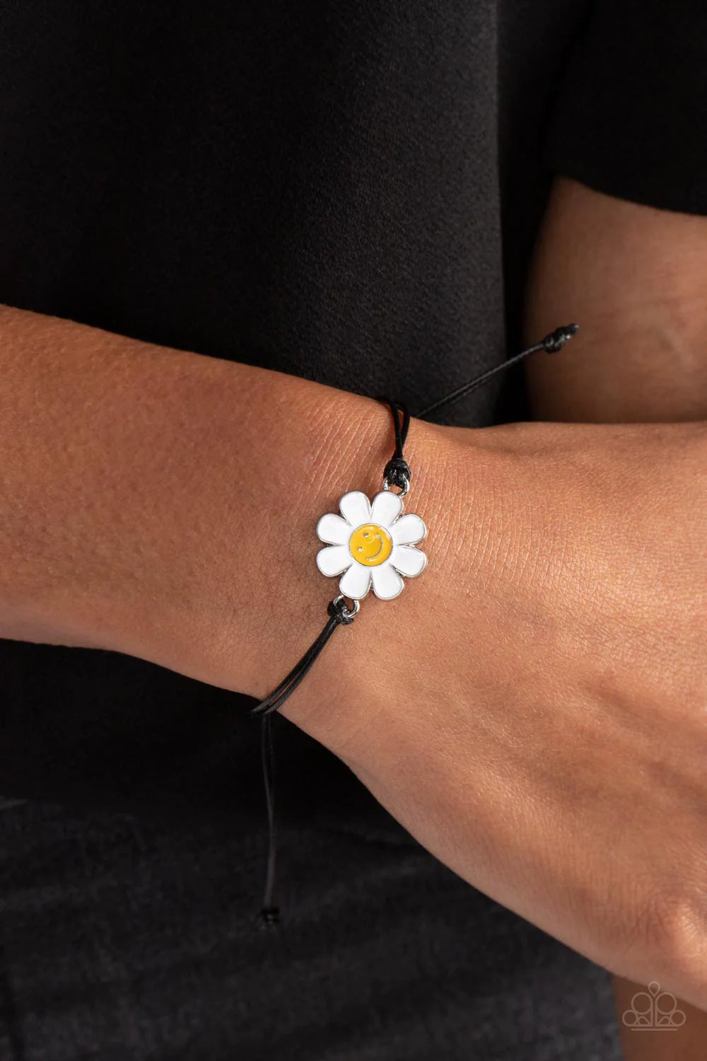 Paparazzi Accessories DAISY Little Thing - Black Held together and centered within soft black cording, a single daisy charm rests. Featuring a silver smiley face in its yellow center, this single flower provides a fashionably, minimalistic statement aroun