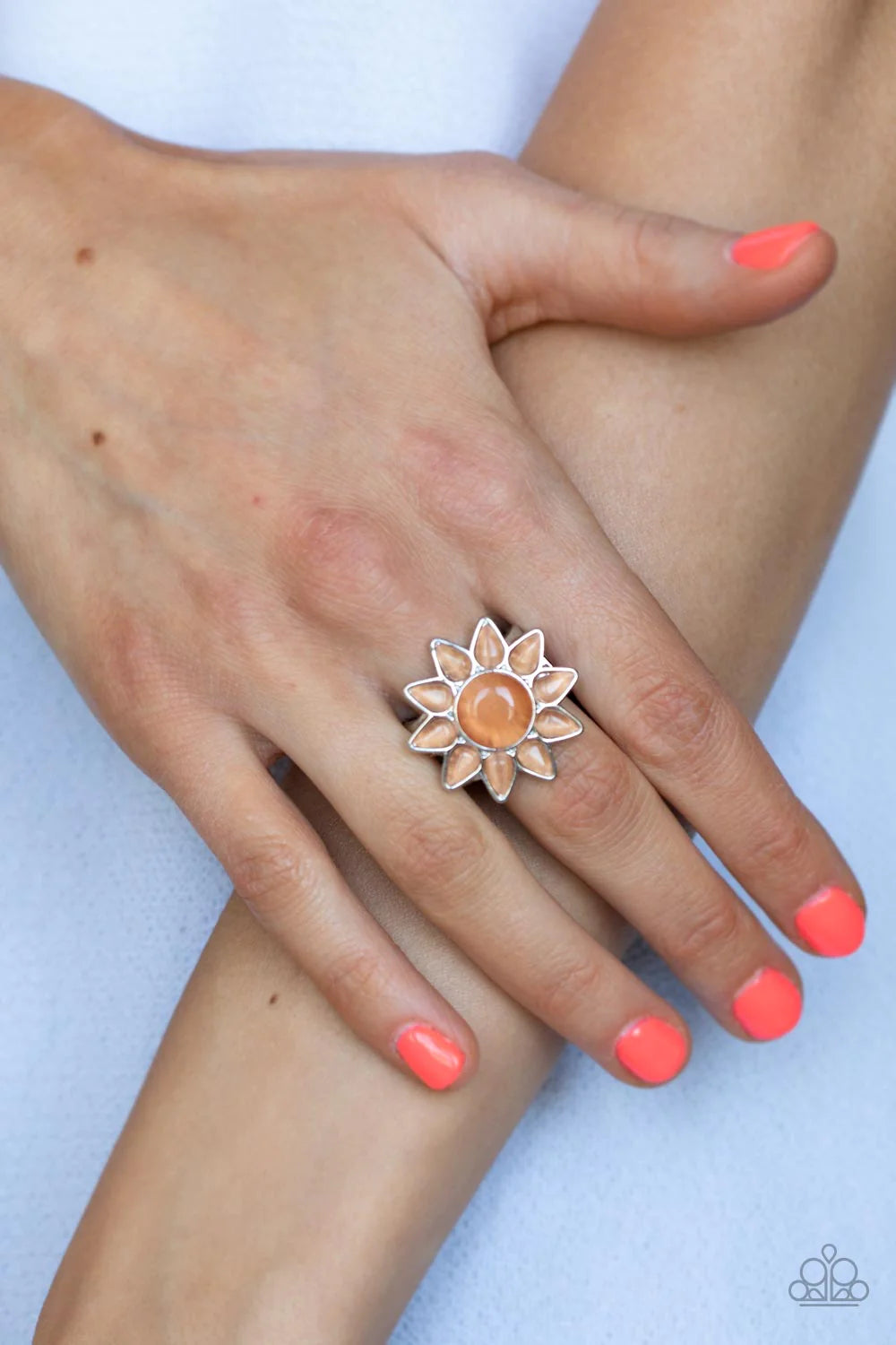 Paparazzi Accessories Blossoming Sunbeams - Orange Dainty teardrop orange cat's eye stones bloom from a round orange cat's eye stone center, creating a whimsical blossom atop the finger. Features a stretchy band for a flexible fit. Sold as one individual