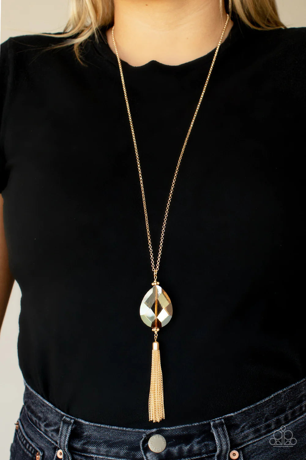 Paparazzi Accessories Interstellar Solstice - Gold Infused with a glistening gold chain tassel, an oversized golden teardrop gem swings from the bottom of a lengthened gold chain for a glamorously glitzy finish. Features an adjustable clasp closure. Sold