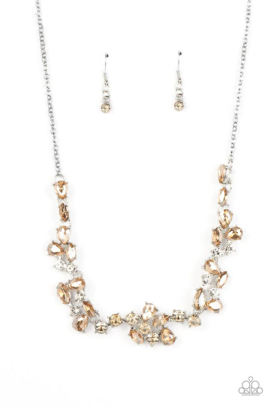Paparazzi Accessories Welcome to the Ice Age - Brown Topaz gems and polished white rhinestones in a variety of inspired shapes gather together into scattered clusters that connect across the collar. The edgy teardrop, marquise, and round shapes attach to