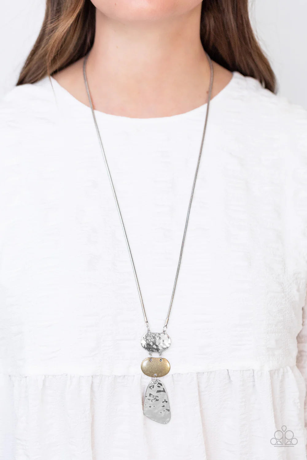 Paparazzi Accessories Riverside Respite - Silver Featuring asymmetrical shapes, hammered silver plates flank a burnished brass frame at the bottom of an extended silver snake chain for an edgy yet rustic look. Features an adjustable clasp closure. Sold as