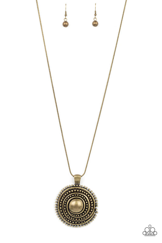 Paparazzi Accessories Solar Swirl - Brass Brushed in a rustic shimmer, a smooth brass ribbon whirls around rows of brass studs that swirl into a dizzying medallion at the bottom of a rounded brass snake chain. Features an adjustable clasp closure. Sold as