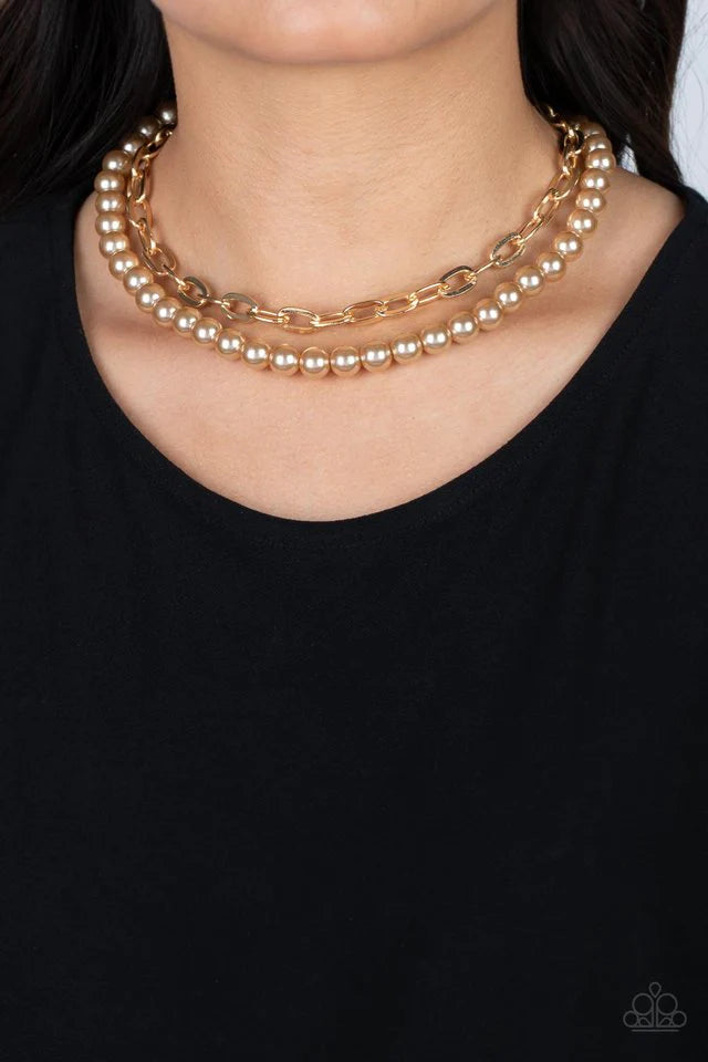 Paparazzi Accessories Suburban Yacht Club - Brown A string of classic pearls in a soft, brown hue is layered with a strand of oversized gold links, creating a gorgeous collision of refinement and grit as they lay along the collar. Features an adjustable c