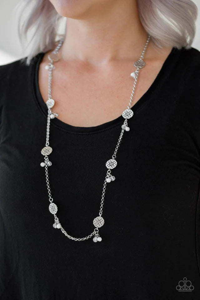 Paparazzi Accessories Color Boost - White Featuring glassy and polished finishes, dainty white beads join ornate silver frames along a shimmery silver chain for a whimsical look. Features an adjustable clasp closure. Sold as one individual necklace. Inclu