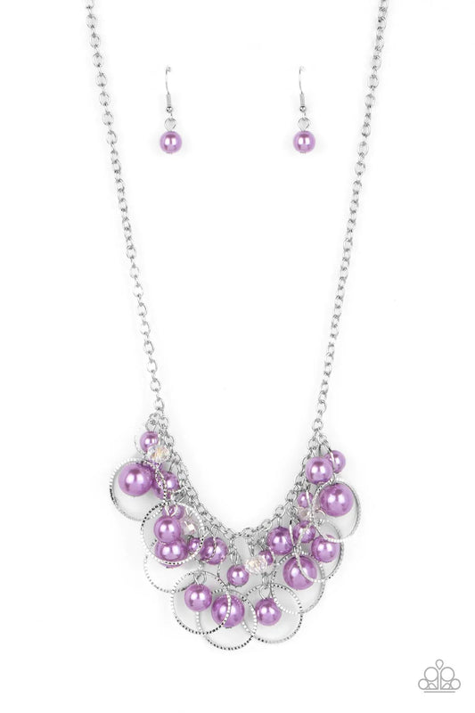 Paparazzi Accessories Ballroom Bliss - Purple Set inside of and surrounded by alternating sizes of silver rings, staggered clusters of lavender pearls and faceted clear crystal beads delicately link into a flirtatious hint of sparkle below the collar. Fea