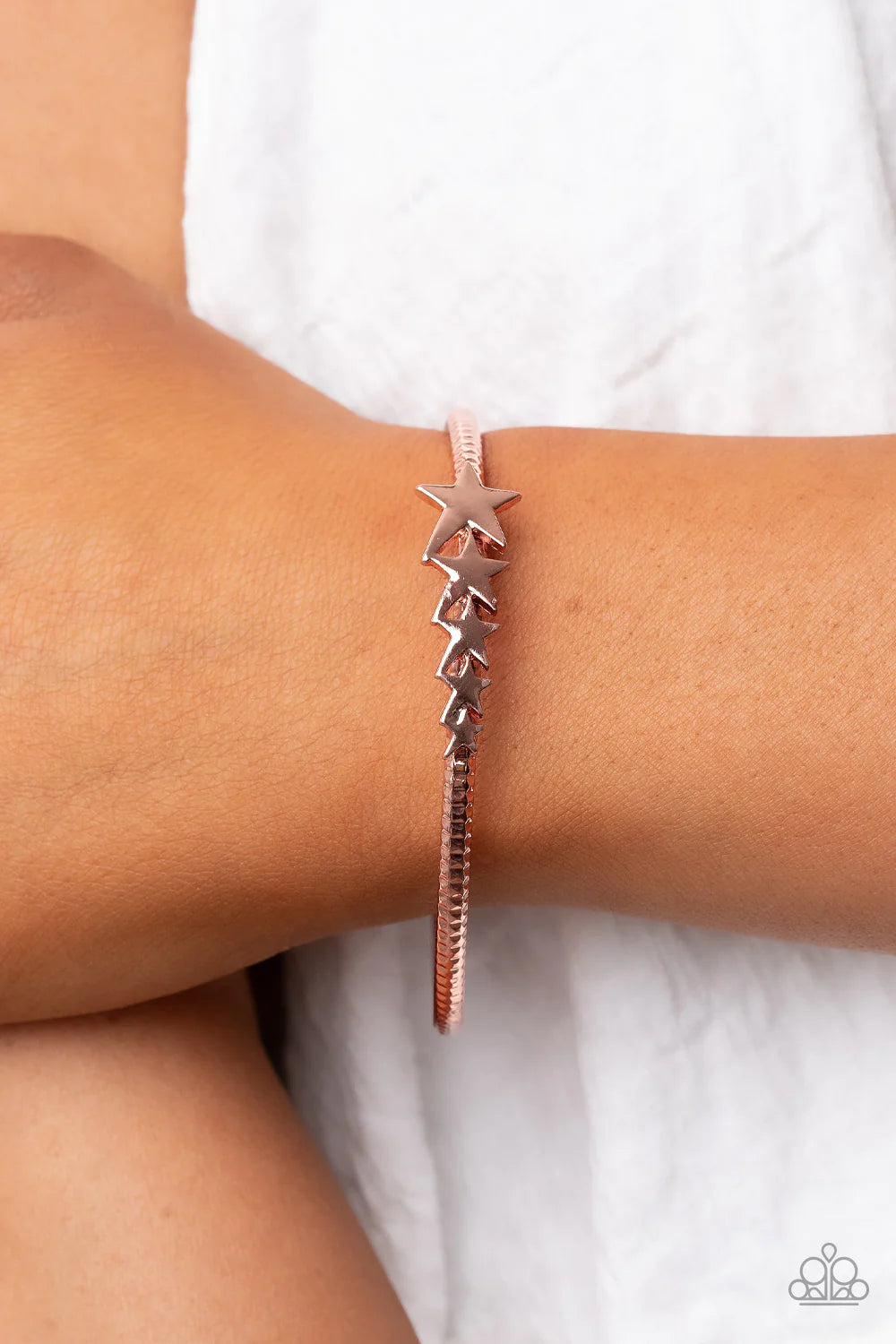 Paparazzi Accessories Astrological A-Lister - Copper Shiny copper stars graduate in size across the center of a hammered shiny copper bangle, creating a stackable stellar centerpiece around the wrist. Sold as one individual bracelet. Jewelry