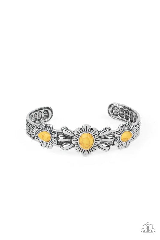 Paparazzi Accessories Winslow Walkabout - Yellow Dotted with yellow stone centers, a trio of summery wildflowers are embossed across the front of a textured silver cuff for a seasonal pop of color. Sold as one individual bracelet.