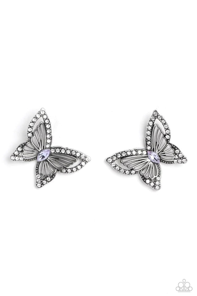 Paparazzi Accessories Wispy Wings - Purple The outer wings of a white gem-studded butterfly feature inner lacy, airy silver wings that bloom from a marquise-cut purple gem center, coalescing into a whimsical 3D butterfly design. Earring attaches to a stan