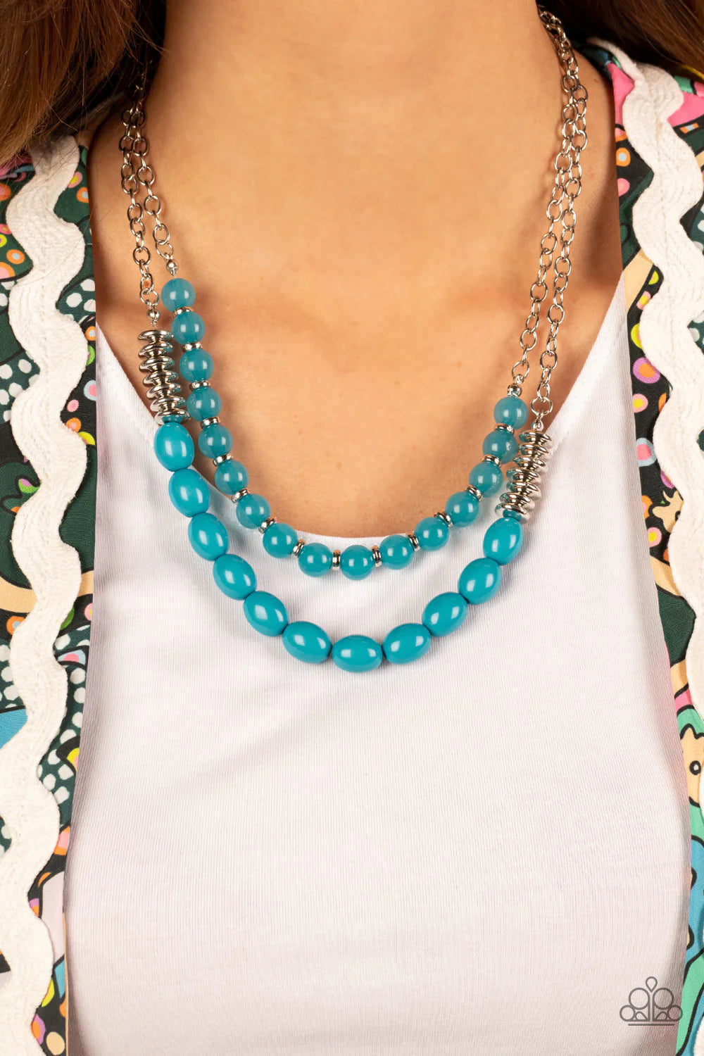 Paparazzi Accessories Venetian Voyage - Blue Infused with silver accents, rows of glassy and acrylic blue beads are threaded along invisible wires at the bottom of two silver chains that layer into a vivacious pop of color below the collar. Features an ad