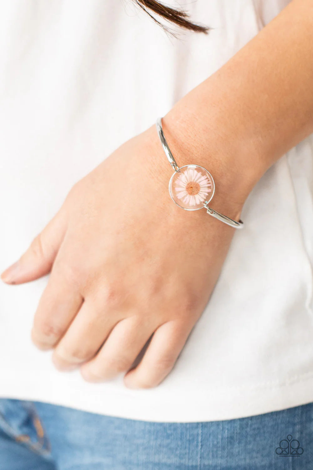 Paparazzi Accessories Cottage Season - Pink Encased in a glassy fitting, a whimsical pink daisy centerpiece attaches to two arcing silver bars around the wrist for an enchanting floral look. Features an adjustable clasp closure. Sold as one individual bra