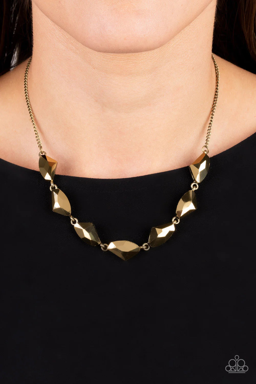 Paparazzi Accessories Raw Rapture - Brass A jagged collection of aurum rhinestones falls along the neckline in a fierce display. The asymmetrical cuts of each rhinestone are emphasized by their dramatic faceted surfaces, bouncing light in every direction