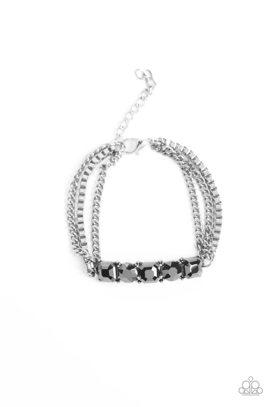 Paparazzi Accessories Tyrant Treasure - Silver A gritty mix of classic silver and silver box-chains stem from a row of faceted hematite, pressed into circular and square silver frames, creating edgy layers around the wrist. Features an adjustable clasp cl