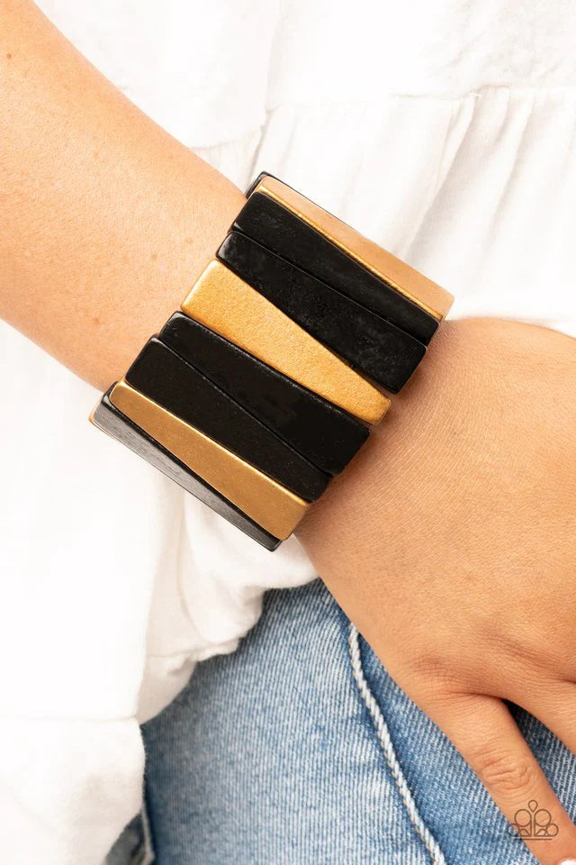 Paparazzi Accessories Bahama Boardwalk - Black Painted in shiny black and brassy gold finishes, triangular wooden beads alternate along stretchy bands around the wrist for an earthy centerpiece.