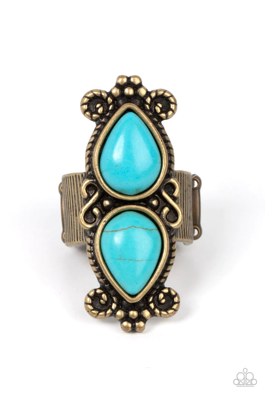 Paparazzi Accessories Adobe Garden - Brass Enhanced with brass ropelike filigree and studded floral details, a pair of turquoise stone teardrops point away from each other atop a ribbed brass band for an authentically artisan style. Features a stretchy ba