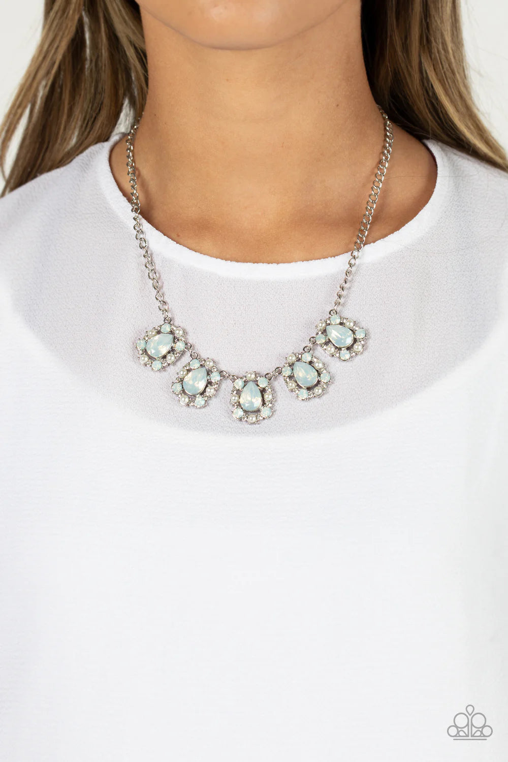 Paparazzi Accessories Pearly Pond - White Encased in shimmery silver frames, a collection of white, opalescent, teardrop gems twinkles above the collar. Dainty white pearls, white crystal-like gems, and white rhinestones surround each teardrop, amplifying