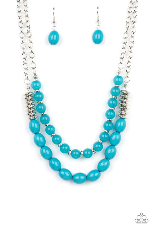 Paparazzi Accessories Venetian Voyage - Blue Infused with silver accents, rows of glassy and acrylic blue beads are threaded along invisible wires at the bottom of two silver chains that layer into a vivacious pop of color below the collar. Features an ad