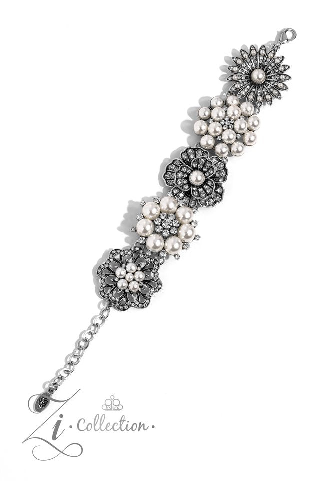 Paparazzi Accessories Self-Made - White Polished white pearls and brilliant white rhinestones bloom into five unique flowers adorned in dizzying detail. Each flower features a unique centerpiece that is encircled by shimmery luminescence and intricate det