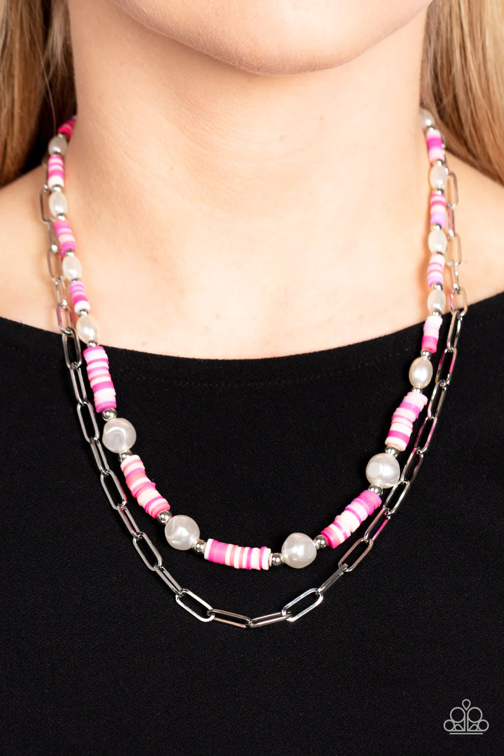 Paparazzi Accessories Tidal Trendsetter - Pink Sections of colorful rubber discs in shades of pink, purple, and white are separated by tiny silver beads and a variety of white baroque pearls to create an unexpected mashup of texture along the collar. A st